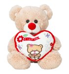 Plush bear sitting with heart in hand
