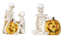 Skeleton sitting near and on pumpkin