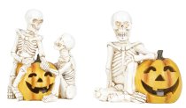 Skeleton sitting near and on pumpkin