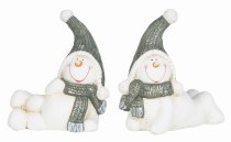 Laughing snowmen lying with scarf and