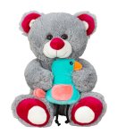 Plush bear sitting with bird in hand