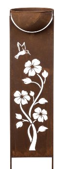 Rusty metal column with bowl as garden