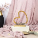 Word "Liebe" with heart on wooden base