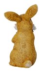 Easter rabbit standing with bouquet of
